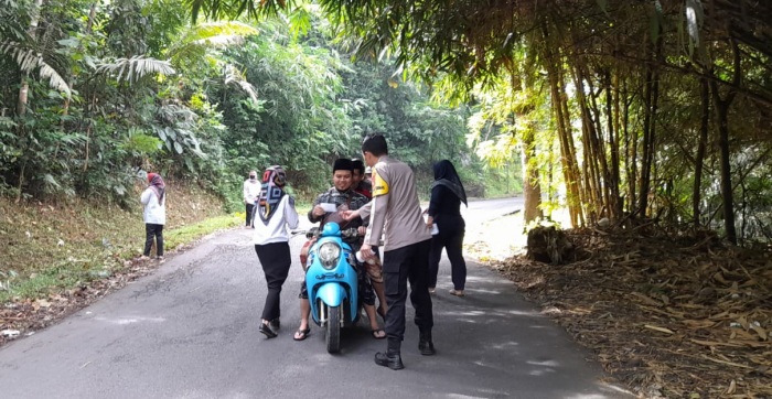 Bersama Warga, Bhabinkamtibmas Desa Madiasari Gotong Royong Bersihkan Jalan Cipancur